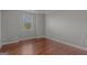 Bedroom with hardwood floors, neutral walls, white trim, and a single window at 560 Birkdale Dr, Fayetteville, GA 30215