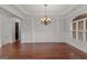 Formal dining room with chandelier, hardwood floors, and paneled walls at 560 Birkdale Dr, Fayetteville, GA 30215