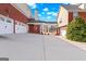 Spacious driveway and porte cochere with a connection between a three-car garage and main house at 560 Birkdale Dr, Fayetteville, GA 30215