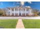 Stunning clubhouse exterior featuring grand white columns and manicured landscaping at 560 Birkdale Dr, Fayetteville, GA 30215