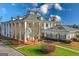 Elegant clubhouse featuring white columns, lush landscaping, and classic architecture at 560 Birkdale Dr, Fayetteville, GA 30215