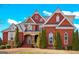 Beautiful red brick home with stone accents and manicured front yard landscaping at 560 Birkdale Dr, Fayetteville, GA 30215