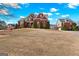 Beautiful brick home with a large front yard, complemented by an attached garage and a tree lined street at 560 Birkdale Dr, Fayetteville, GA 30215