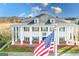 Clubhouse featuring prominent columns and an American flag at 560 Birkdale Dr, Fayetteville, GA 30215