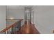 Hallway with hardwood floors, decorative railing and trim, and neutral colored walls at 560 Birkdale Dr, Fayetteville, GA 30215