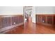 Hallway featuring hardwood floors, detailed wood trim and an open doorway at 560 Birkdale Dr, Fayetteville, GA 30215