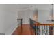Upstairs hallway with dark wood floors and a wrought iron railing at 560 Birkdale Dr, Fayetteville, GA 30215