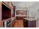 Gourmet kitchen with stainless steel appliances and custom dark wood cabinets at 560 Birkdale Dr, Fayetteville, GA 30215