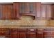 Close-up of a kitchen with dark wood cabinets and granite countertops at 560 Birkdale Dr, Fayetteville, GA 30215
