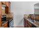 Partial view of a kitchen with stainless steel appliances, tiled backsplash, and granite countertops at 560 Birkdale Dr, Fayetteville, GA 30215