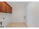 Laundry room featuring tile floors and upper cabinets offers convenience and extra storage space at 560 Birkdale Dr, Fayetteville, GA 30215