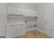 Practical laundry room with ample white cabinets and a neutral color scheme at 560 Birkdale Dr, Fayetteville, GA 30215