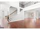 Large open-concept living room showcasing a beautiful staircase, fireplace, and natural light at 560 Birkdale Dr, Fayetteville, GA 30215