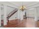 Open-concept living room with fireplace, hardwood floors, staircase and recessed lighting at 560 Birkdale Dr, Fayetteville, GA 30215
