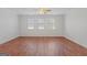 Bright living room featuring wood floors and multiple windows creating a warm and inviting atmosphere at 560 Birkdale Dr, Fayetteville, GA 30215