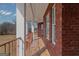 Long covered patio overlooking the landscaped backyard and a fenced in pool at 560 Birkdale Dr, Fayetteville, GA 30215