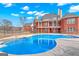 Large in-ground pool surrounded by a brick home with second story balcony at 560 Birkdale Dr, Fayetteville, GA 30215