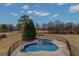 An aerial view of the kidney-shaped pool and fenced in yard in a landscaped backyard at 560 Birkdale Dr, Fayetteville, GA 30215