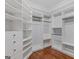 A spacious walk-in closet offers ample storage with custom shelving and hanging racks at 560 Birkdale Dr, Fayetteville, GA 30215