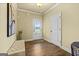 Bright entryway featuring hardwood floors, a tufted bench, and view to the exterior through a glass door at 2393 Aukerman Trce # 78, Hampton, GA 30228