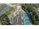 Overhead view showcasing community amenities, including a pool, tennis courts, parking lot, and pond at 545 Discovery Lake Dr # 409, Fayetteville, GA 30215