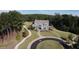 Birds eye view of a charming home with manicured lawns and a circular driveway nestled among trees at 545 Discovery Lake Dr # 409, Fayetteville, GA 30215