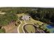 Drone shot displaying a well-maintained property, tennis court, and surrounding landscape at 545 Discovery Lake Dr # 409, Fayetteville, GA 30215