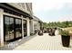 Spacious outdoor deck featuring comfortable seating, a fireplace, and scenic views of the surrounding landscape at 545 Discovery Lake Dr # 409, Fayetteville, GA 30215