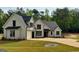 Stylish modern farmhouse featuring a manicured lawn, 3-car garage, and charming curb appeal at 545 Discovery Lake Dr # 409, Fayetteville, GA 30215