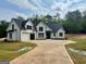 Charming modern farmhouse with a concrete driveway and an attached three-car garage at 545 Discovery Lake Dr # 409, Fayetteville, GA 30215
