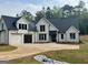 Beautiful modern farmhouse-style home with a three-car garage and a well-manicured lawn at 545 Discovery Lake Dr # 409, Fayetteville, GA 30215
