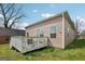Backyard view featuring a deck with outdoor seating, and a well-maintained lawn at 906 Sims Sw St, Atlanta, GA 30310