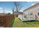 Backyard view featuring a wooden fence, a deck with outdoor seating, and a well-maintained lawn at 906 Sims Sw St, Atlanta, GA 30310