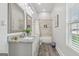Elegant bathroom with a double sink vanity, marble countertops, and a bathtub, offering a luxurious experience at 906 Sims Sw St, Atlanta, GA 30310
