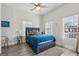 Inviting bedroom with a plush bed, ceiling fan, and abundant natural light from multiple windows, perfect for relaxation at 906 Sims Sw St, Atlanta, GA 30310
