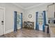 Bright dining area with wood floors, blue curtains, and a small table set for two at 906 Sims Sw St, Atlanta, GA 30310