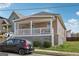 Exterior view of home showing front porch, brown siding, and a black car parked in the driveway at 906 Sims Sw St, Atlanta, GA 30310