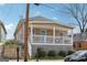 Charming home featuring a covered front porch with white railings and a light blue front door at 906 Sims Sw St, Atlanta, GA 30310