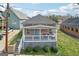 Charming bungalow featuring a cozy front porch with white railings and a bright blue front door at 906 Sims Sw St, Atlanta, GA 30310