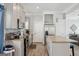 Modern kitchen with stainless appliances, gray cabinets, and a stylish marble backsplash at 906 Sims Sw St, Atlanta, GA 30310