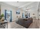 Open living room with gray sofa, recessed lighting, a ceiling fan, and stylish gray flooring at 906 Sims Sw St, Atlanta, GA 30310