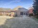 Brick home featuring a covered patio with a view of the backyard at 1832 Glenwood Ln, Snellville, GA 30078