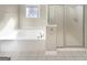 Elegant bathroom featuring a soaking tub and separate glass shower enclosure at 1832 Glenwood Ln, Snellville, GA 30078