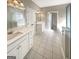 Bright bathroom with double vanity, white cabinets, and tile flooring at 1832 Glenwood Ln, Snellville, GA 30078