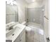Clean, well-lit bathroom with a shower-tub combination and neutral tile at 1832 Glenwood Ln, Snellville, GA 30078