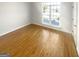 Bright, minimalist bedroom with hardwood floors and a large window at 1832 Glenwood Ln, Snellville, GA 30078