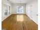 Bright dining room with hardwood floors, natural light, and classic chandelier fixture at 1832 Glenwood Ln, Snellville, GA 30078