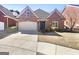 Charming brick home featuring manicured landscaping and a two-car garage at 1832 Glenwood Ln, Snellville, GA 30078
