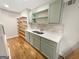 Kitchenette featuring cabinets, countertop space, sink, and floating shelves at 1832 Glenwood Ln, Snellville, GA 30078