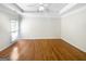 Large bedroom with hardwood floors, tray ceiling, and natural light at 1832 Glenwood Ln, Snellville, GA 30078